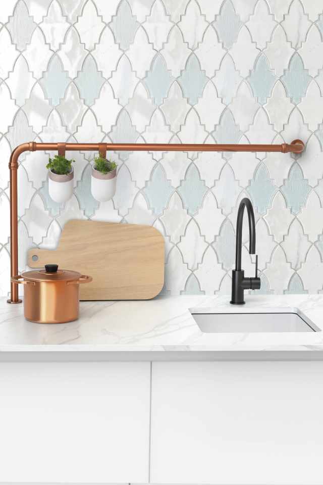 blue fleur glass mosaic tile behind kitchen sink